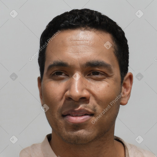 Joyful black young-adult male with short  black hair and brown eyes