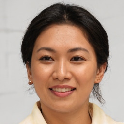 Joyful asian young-adult female with medium  brown hair and brown eyes