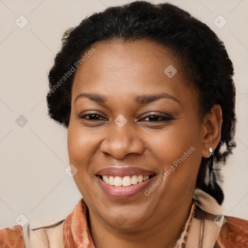 Joyful black adult female with short  brown hair and brown eyes