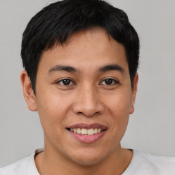 Joyful asian young-adult male with short  brown hair and brown eyes