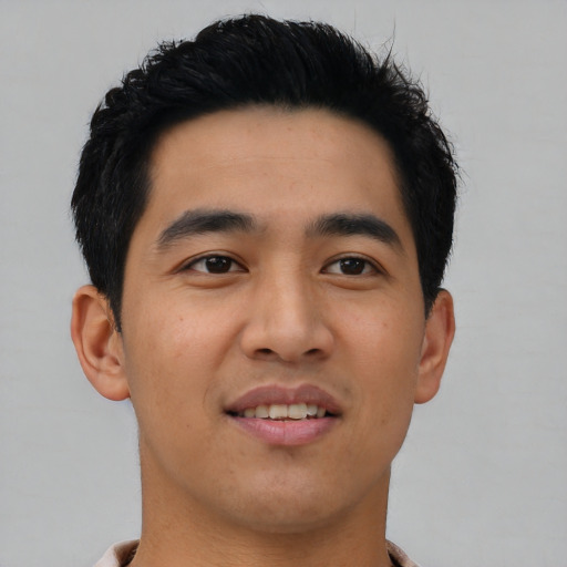 Joyful asian young-adult male with short  black hair and brown eyes