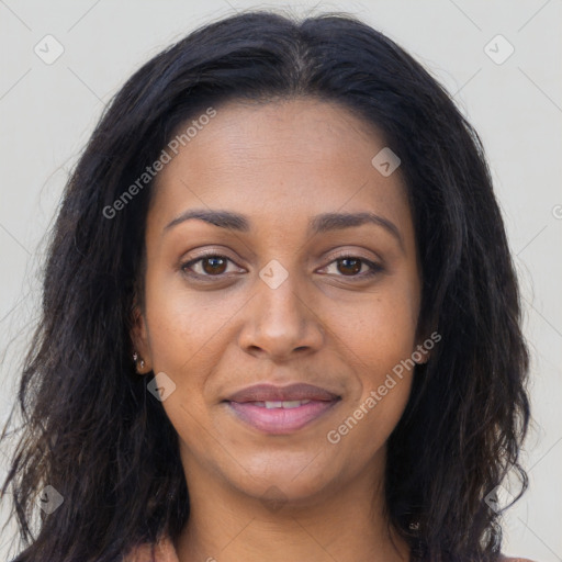 Joyful black young-adult female with long  brown hair and brown eyes