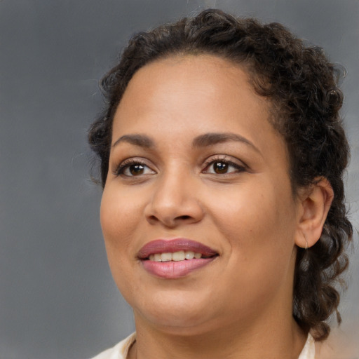 Joyful black young-adult female with medium  brown hair and brown eyes