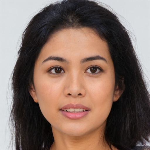 Joyful asian young-adult female with long  brown hair and brown eyes