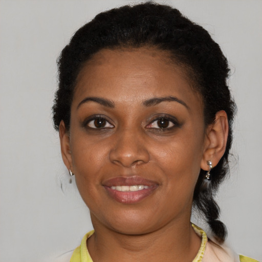 Joyful black young-adult female with short  brown hair and brown eyes