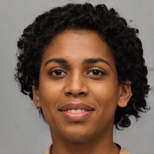 Joyful black young-adult female with short  brown hair and brown eyes