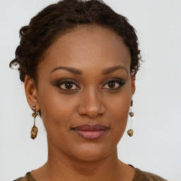 Joyful black young-adult female with short  brown hair and brown eyes