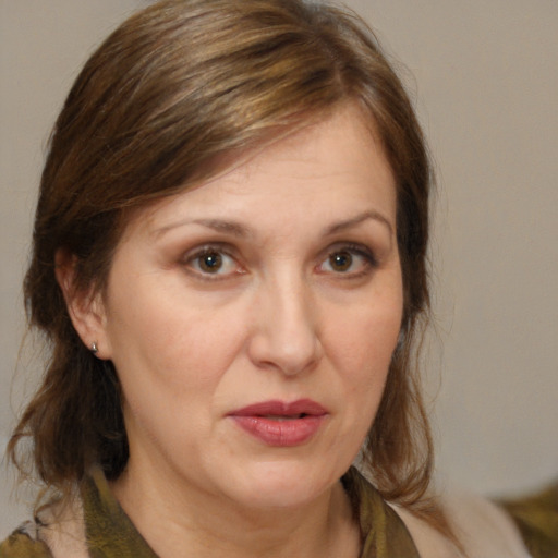 Joyful white adult female with medium  brown hair and brown eyes