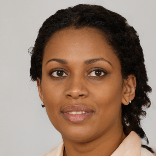 Joyful black young-adult female with medium  black hair and brown eyes