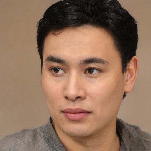 Joyful asian young-adult male with short  brown hair and brown eyes