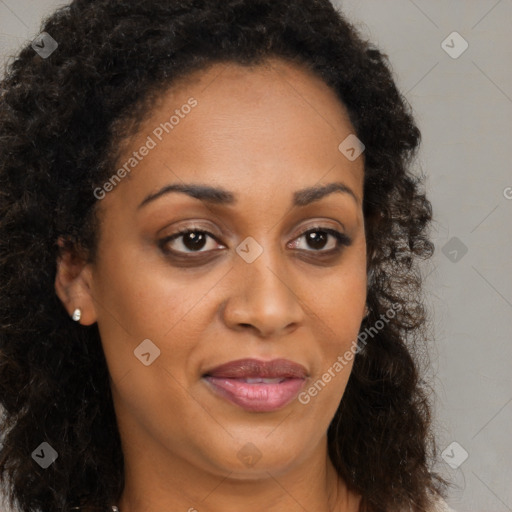 Joyful black young-adult female with long  brown hair and brown eyes