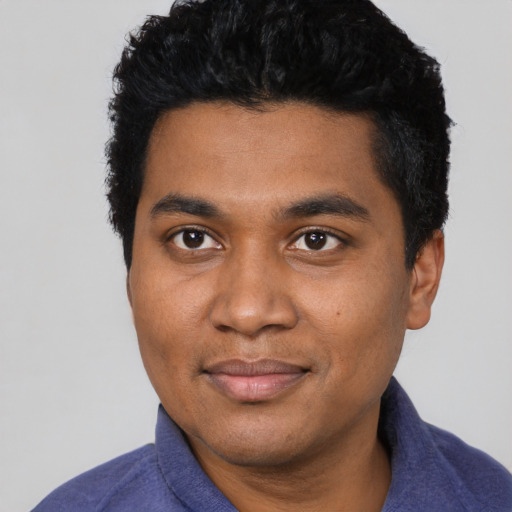 Joyful black young-adult male with short  black hair and brown eyes