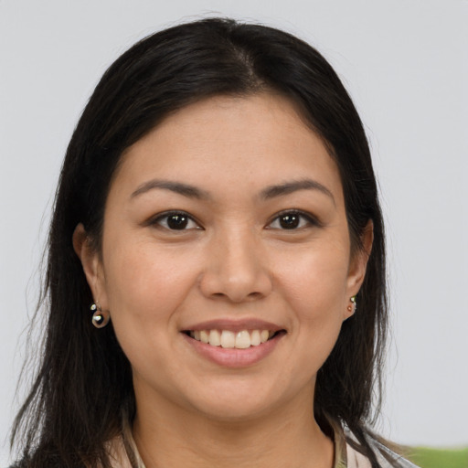 Joyful white young-adult female with long  brown hair and brown eyes
