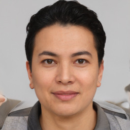 Joyful asian young-adult male with short  black hair and brown eyes