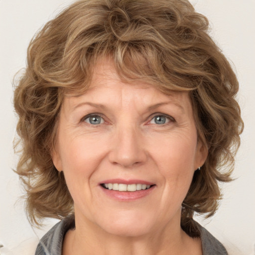 Joyful white adult female with medium  brown hair and blue eyes