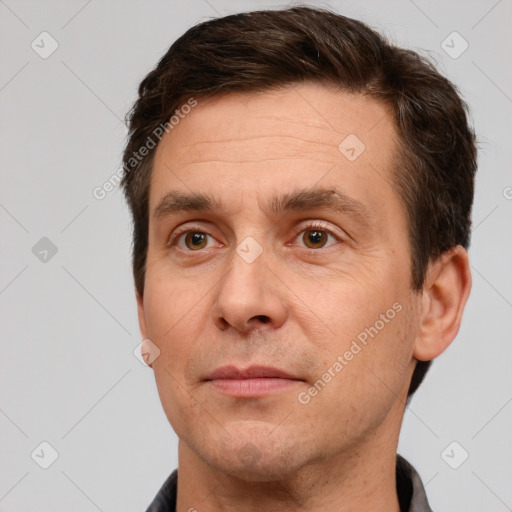 Joyful white adult male with short  brown hair and brown eyes