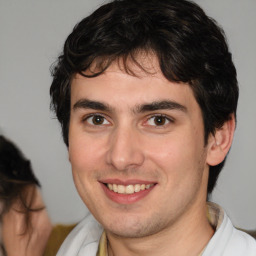 Joyful white young-adult male with medium  brown hair and brown eyes