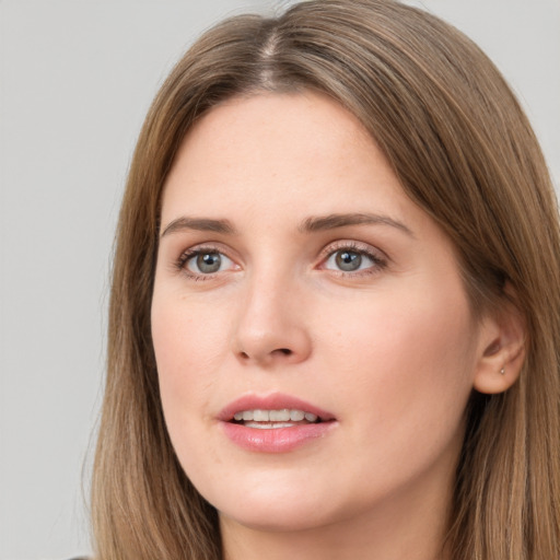 Joyful white young-adult female with long  brown hair and grey eyes