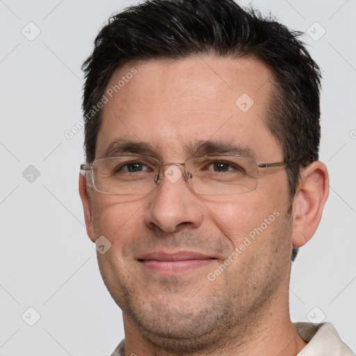 Joyful white adult male with short  brown hair and brown eyes