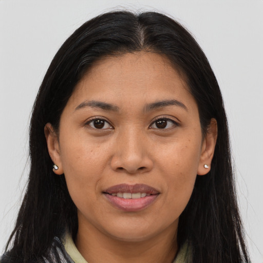 Joyful asian young-adult female with long  brown hair and brown eyes