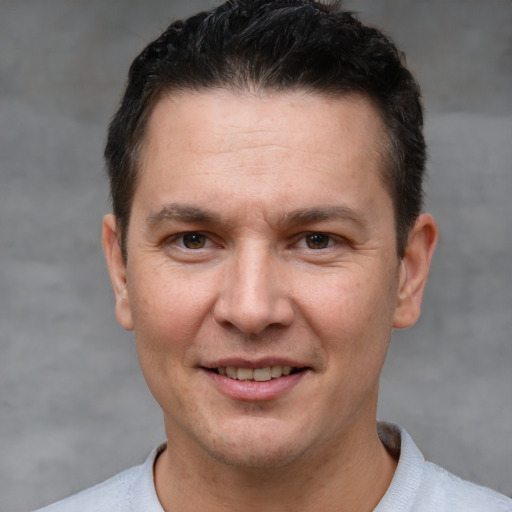 Joyful white adult male with short  brown hair and brown eyes