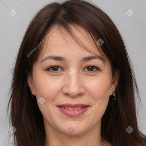 Joyful white adult female with long  brown hair and brown eyes