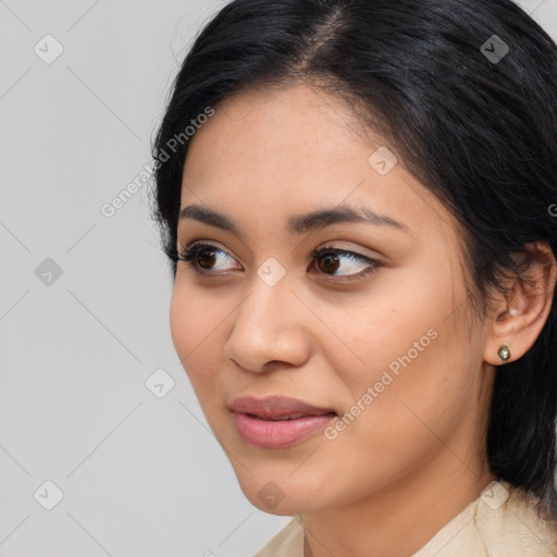 Joyful latino young-adult female with medium  brown hair and brown eyes