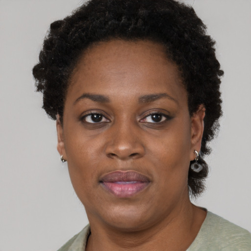 Joyful black adult female with short  brown hair and brown eyes