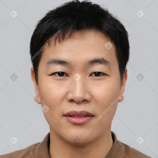 Joyful asian young-adult male with short  black hair and brown eyes