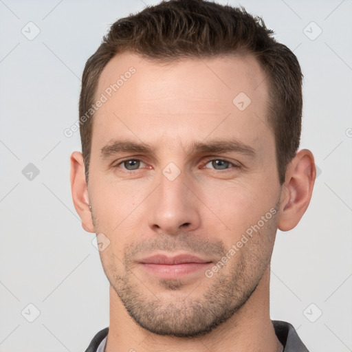 Joyful white young-adult male with short  brown hair and brown eyes