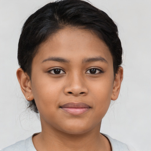 Joyful latino child female with short  brown hair and brown eyes