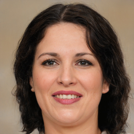 Joyful white adult female with medium  brown hair and brown eyes