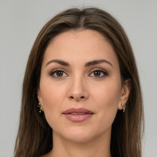 Joyful white young-adult female with long  brown hair and brown eyes