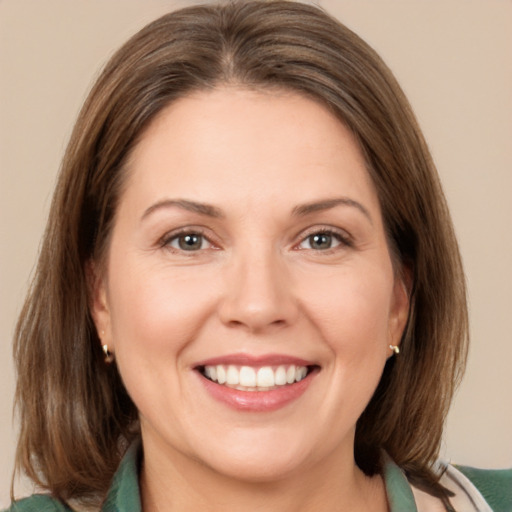 Joyful white adult female with medium  brown hair and brown eyes