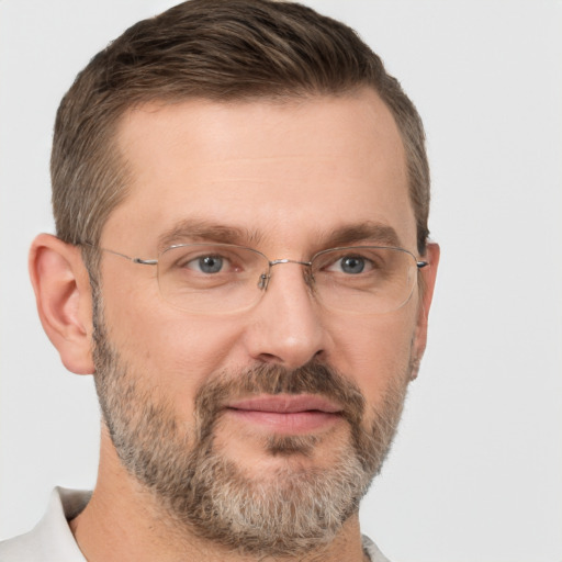 Joyful white adult male with short  brown hair and brown eyes