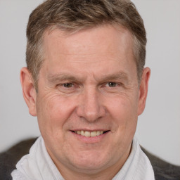 Joyful white middle-aged male with short  brown hair and brown eyes