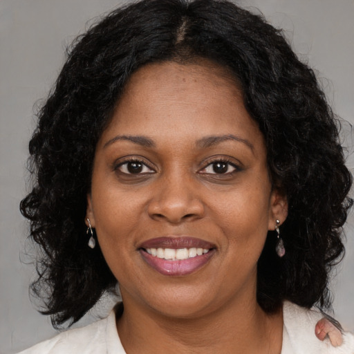 Joyful black young-adult female with medium  brown hair and brown eyes