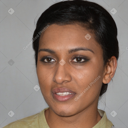 Joyful black young-adult female with short  black hair and brown eyes