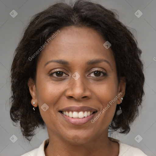 Joyful black adult female with medium  brown hair and brown eyes