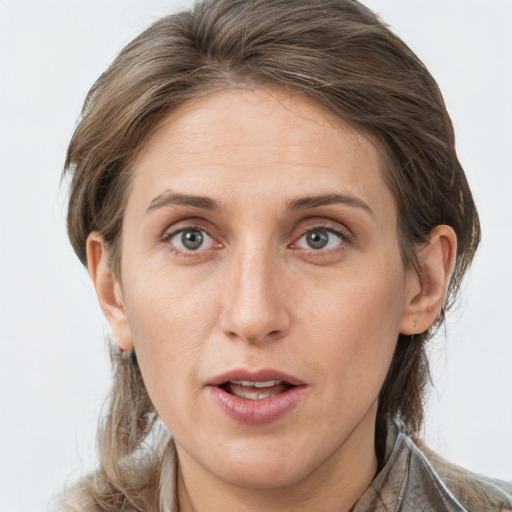 Joyful white adult female with medium  brown hair and grey eyes