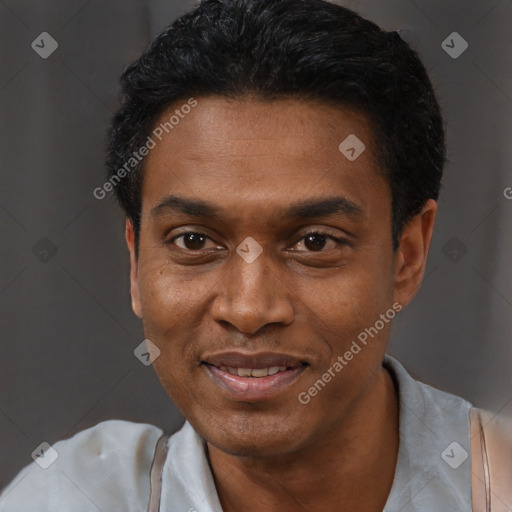 Joyful black young-adult male with short  black hair and brown eyes
