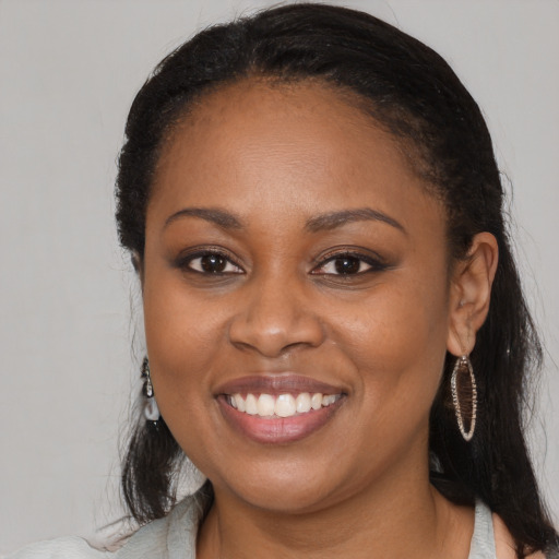Joyful black young-adult female with medium  brown hair and brown eyes