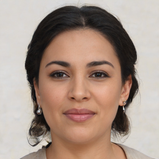 Joyful latino young-adult female with medium  brown hair and brown eyes