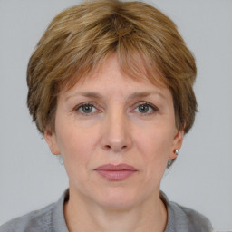 Joyful white adult female with medium  brown hair and grey eyes