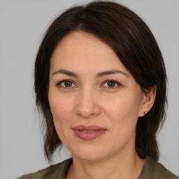 Joyful white adult female with medium  brown hair and brown eyes