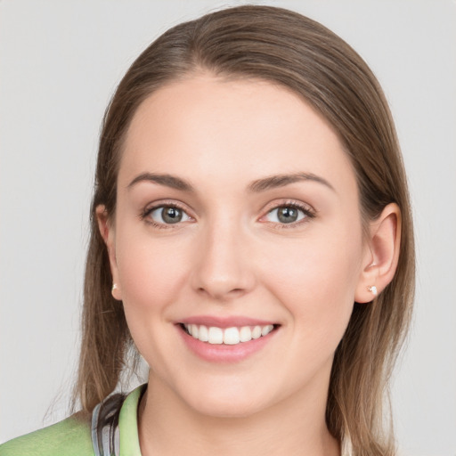 Joyful white young-adult female with medium  brown hair and green eyes