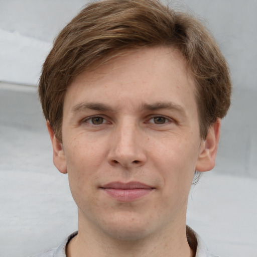 Joyful white adult male with short  brown hair and grey eyes