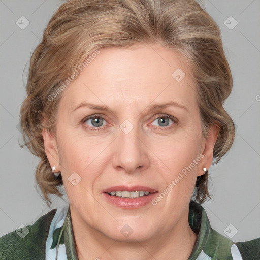 Joyful white adult female with medium  brown hair and blue eyes