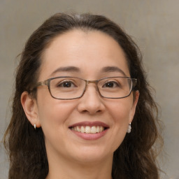 Joyful white adult female with long  brown hair and brown eyes