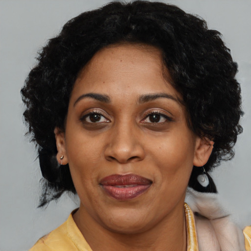 Joyful black adult female with medium  black hair and brown eyes